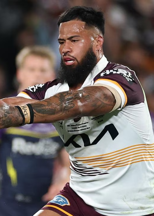 Two rugby players in action during a match, one in a purple jersey and the other in a white and brown jersey.