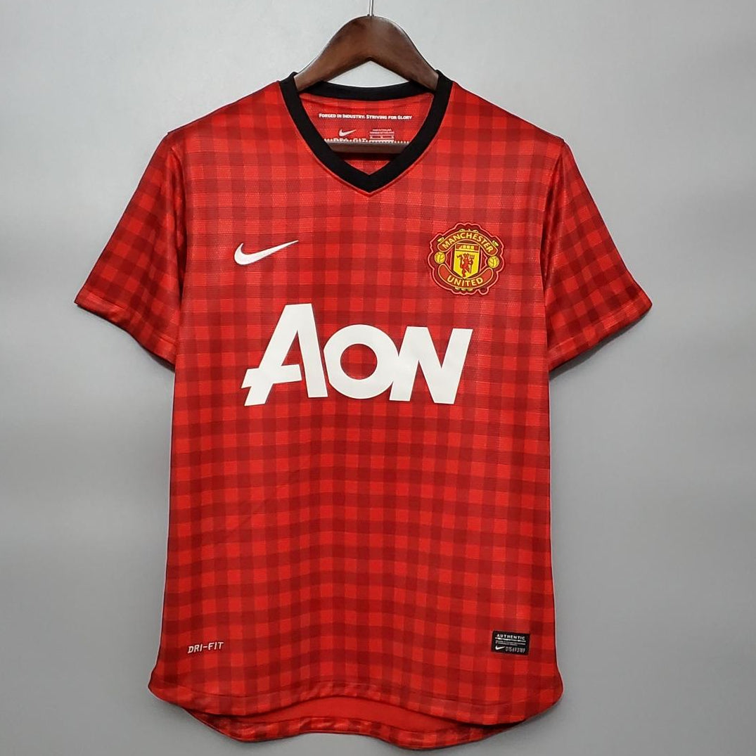 Red checkered sports jersey with Nike and AON logos on a gray background