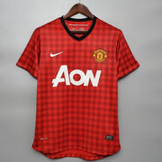 Red checkered sports jersey with Nike and AON logos on a gray background