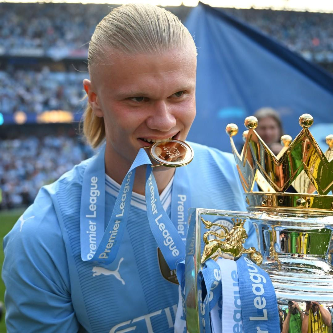 Soccer player in a blue jersey celebrating in front of a crowd