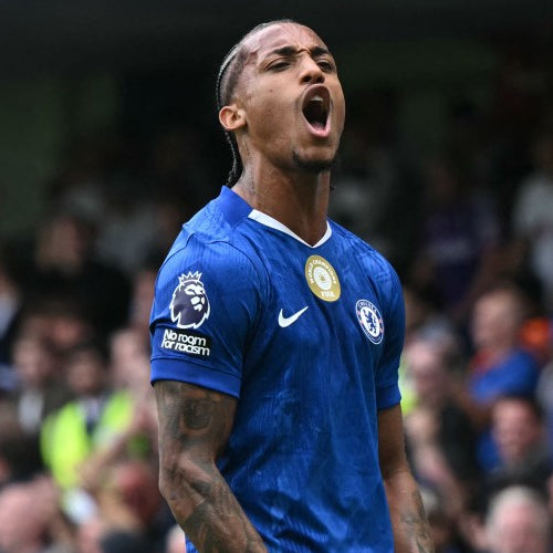 Soccer player in a blue jersey celebrating in front of a crowd