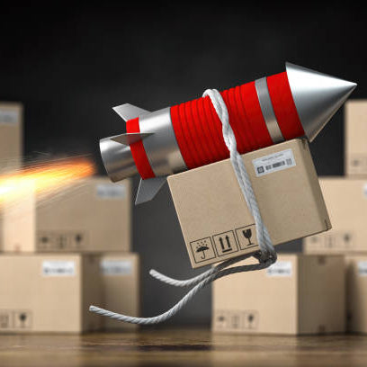 Cardboard box with a rocket engine launching among other boxes on a dark background