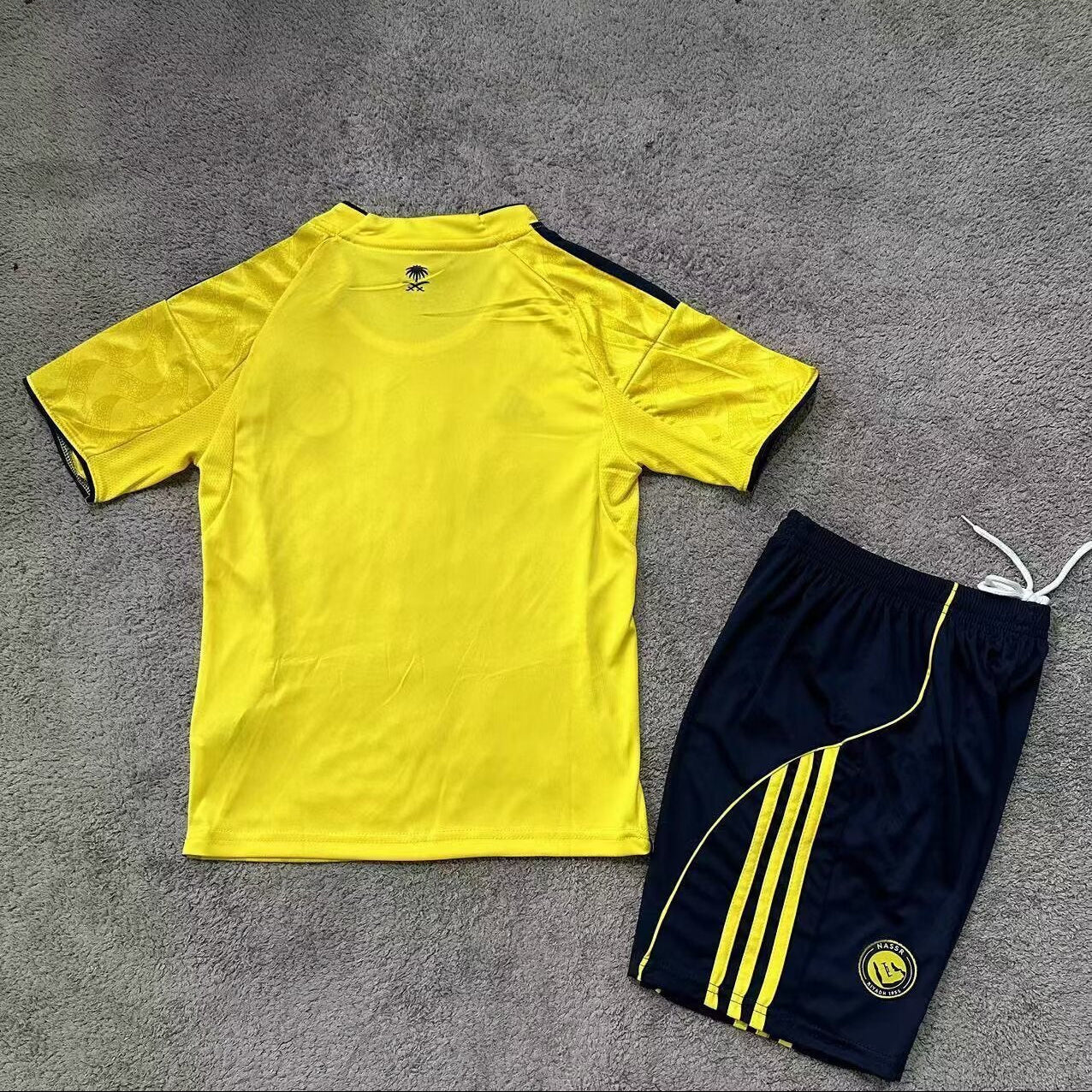 Adidas Al Nassr 2025/26 home youth kit back view yellow shirt and navy shorts
