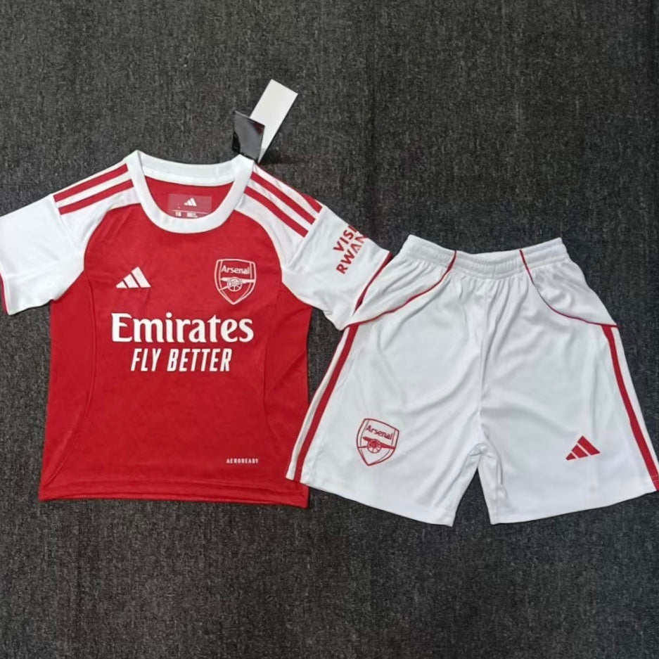 Adidas Arsenal 2025/26 home kids football kit front view red and white jersey with white shorts

