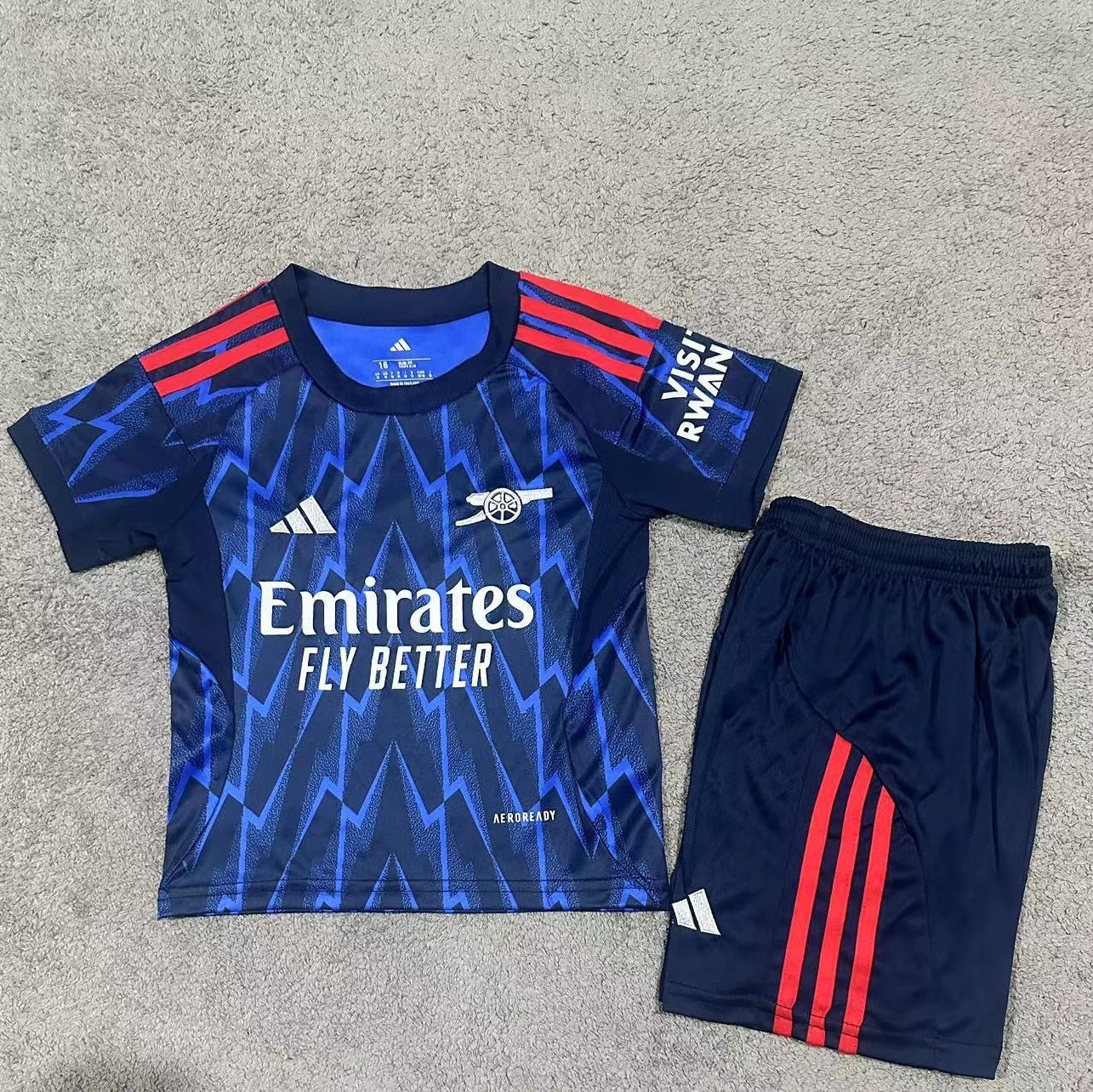 Adidas Arsenal away kit 2025 26 kids front view navy jersey and shorts
