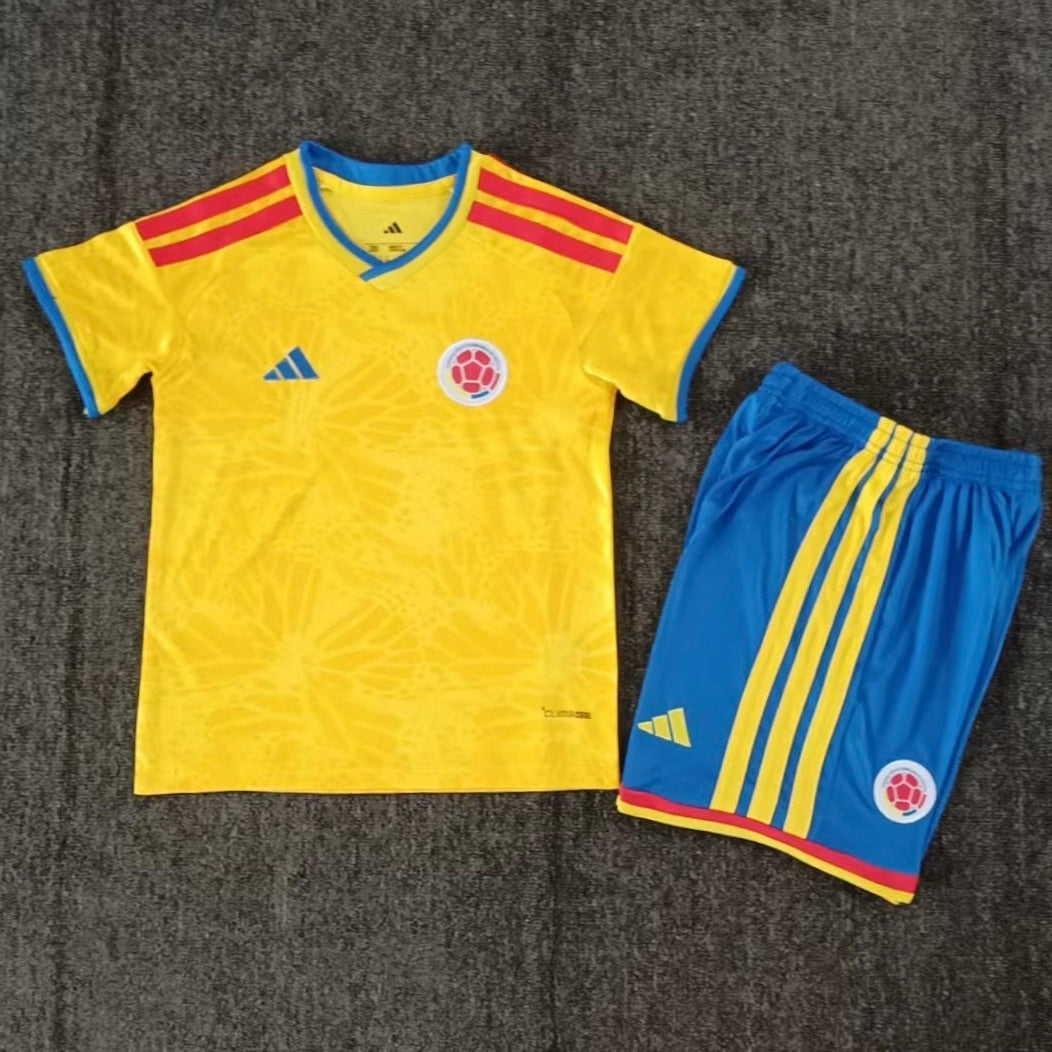 Adidas Colombia home kit 2026/27 kids set front view yellow jersey with blue shorts
