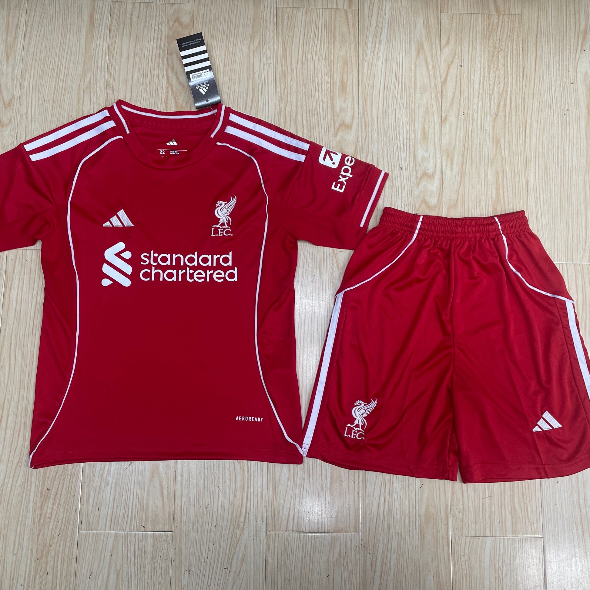 Adidas Liverpool 2025/26 home kids football kit front view red jersey with red shorts
