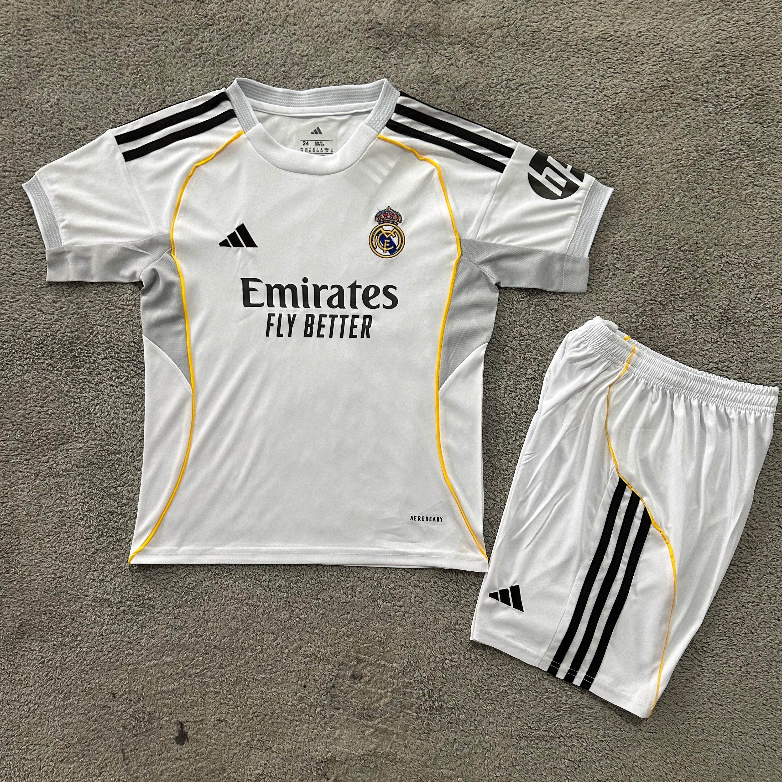 Adidas Real Madrid 2025/26 home kids football kit front view white jersey with matching shorts
