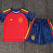 Adidas Spain home kit 2026/27 kids set front view red jersey with navy shorts
