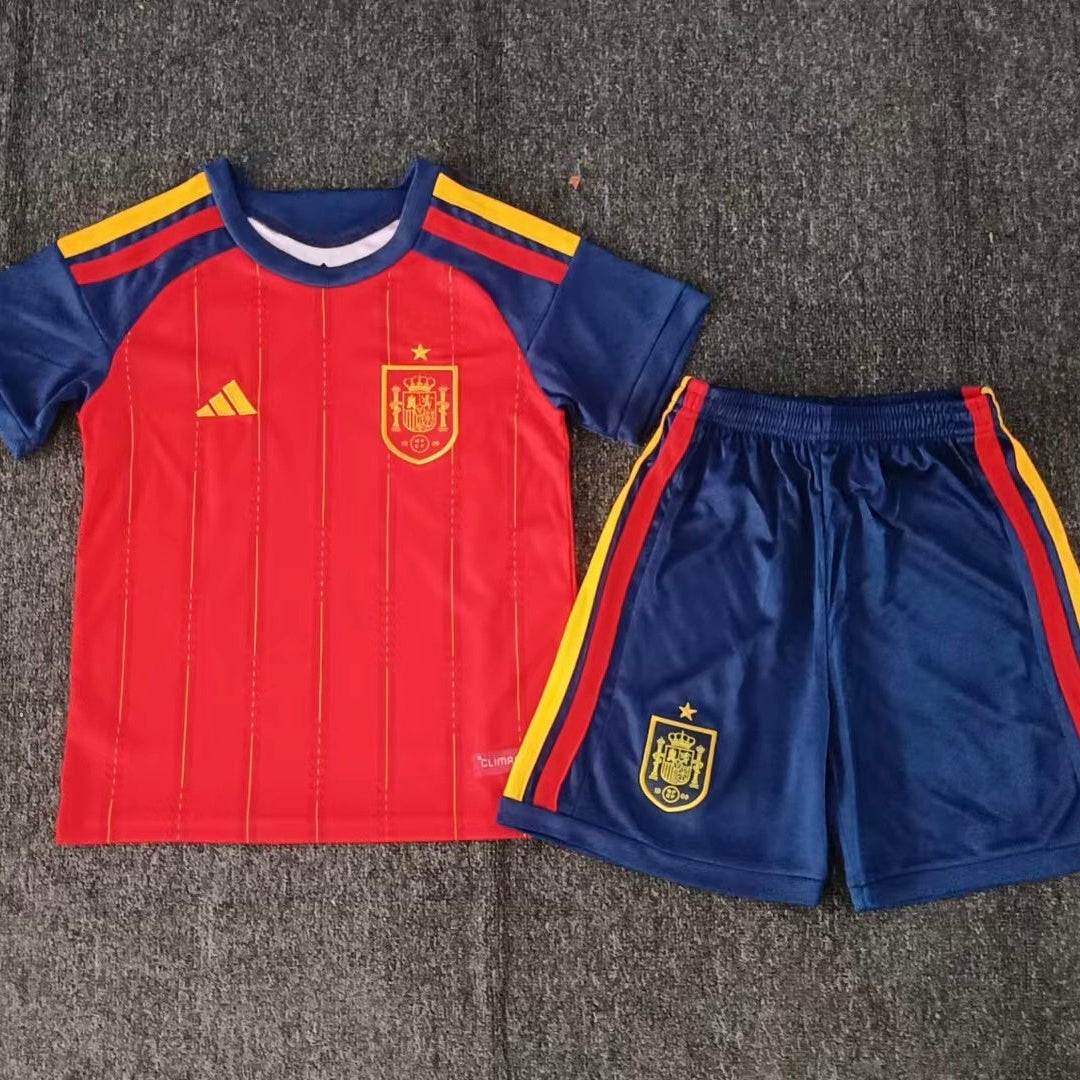 Adidas Spain home kit 2026/27 kids set front view red jersey with navy shorts
