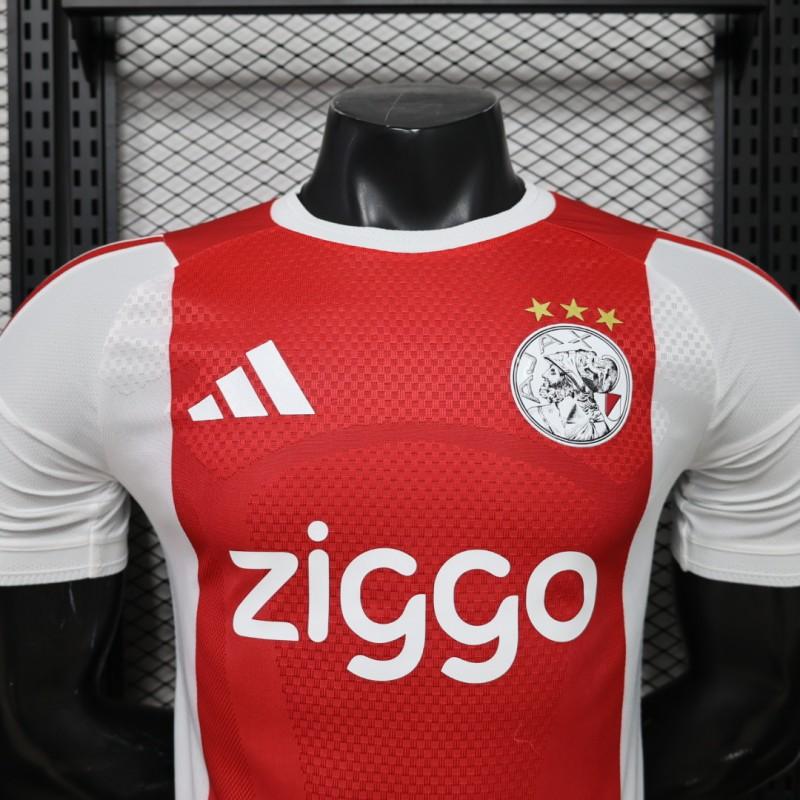 Ajax Home Jersey 2026/27 crest detail with three gold stars and Ziggo sponsor