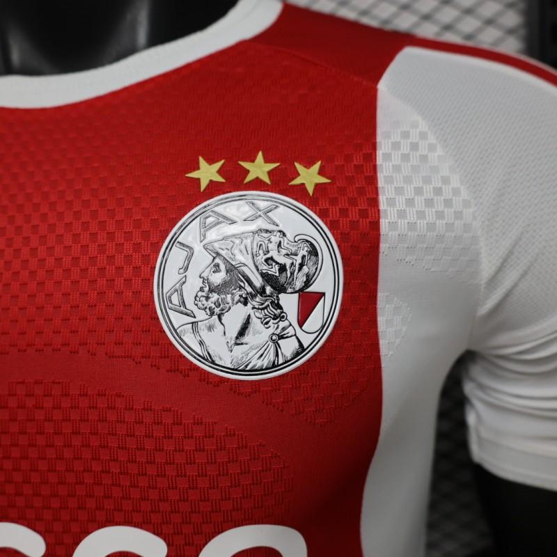 Ajax Home Jersey 2026/27 crest detail with three gold stars and Ziggo sponsor