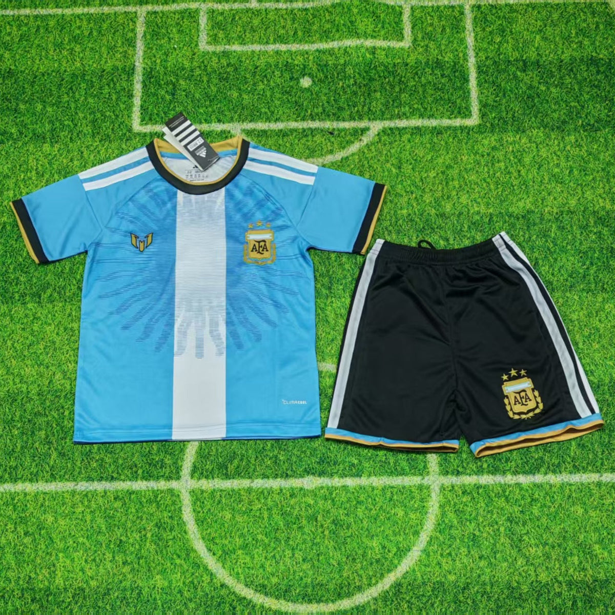 Argentina Special Edition Jersey 2026 Kids Set front view with sky blue and white shirt, gold details and matching black shorts