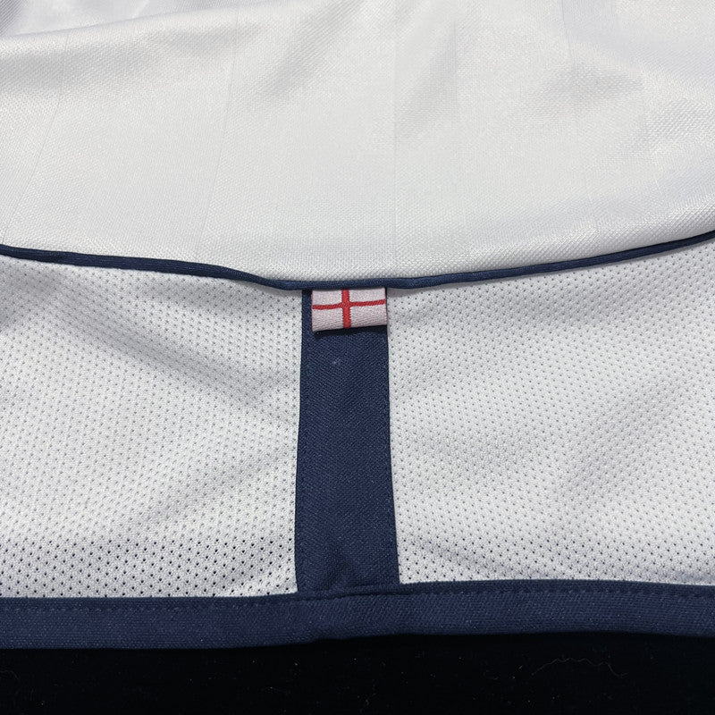 England Home Jersey 2002 back neck detail with small England flag and navy trim