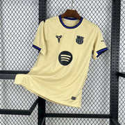 FC Barcelona Away Jersey 2025/26 front view in soft gold with black, blue and purple trim, Barcelona crest and Spotify sponsor
