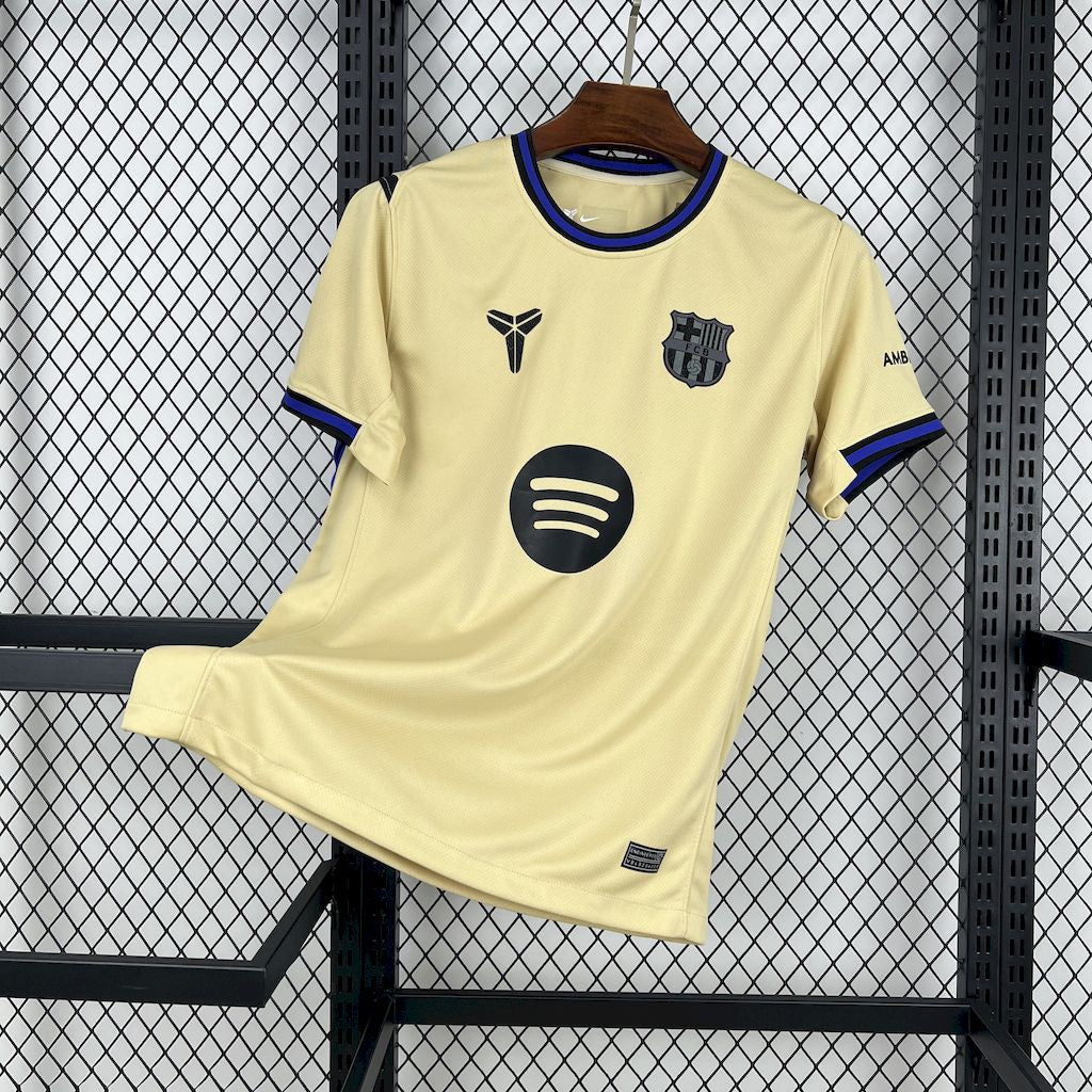 FC Barcelona Away Jersey 2025/26 front view in soft gold with black, blue and purple trim, Barcelona crest and Spotify sponsor