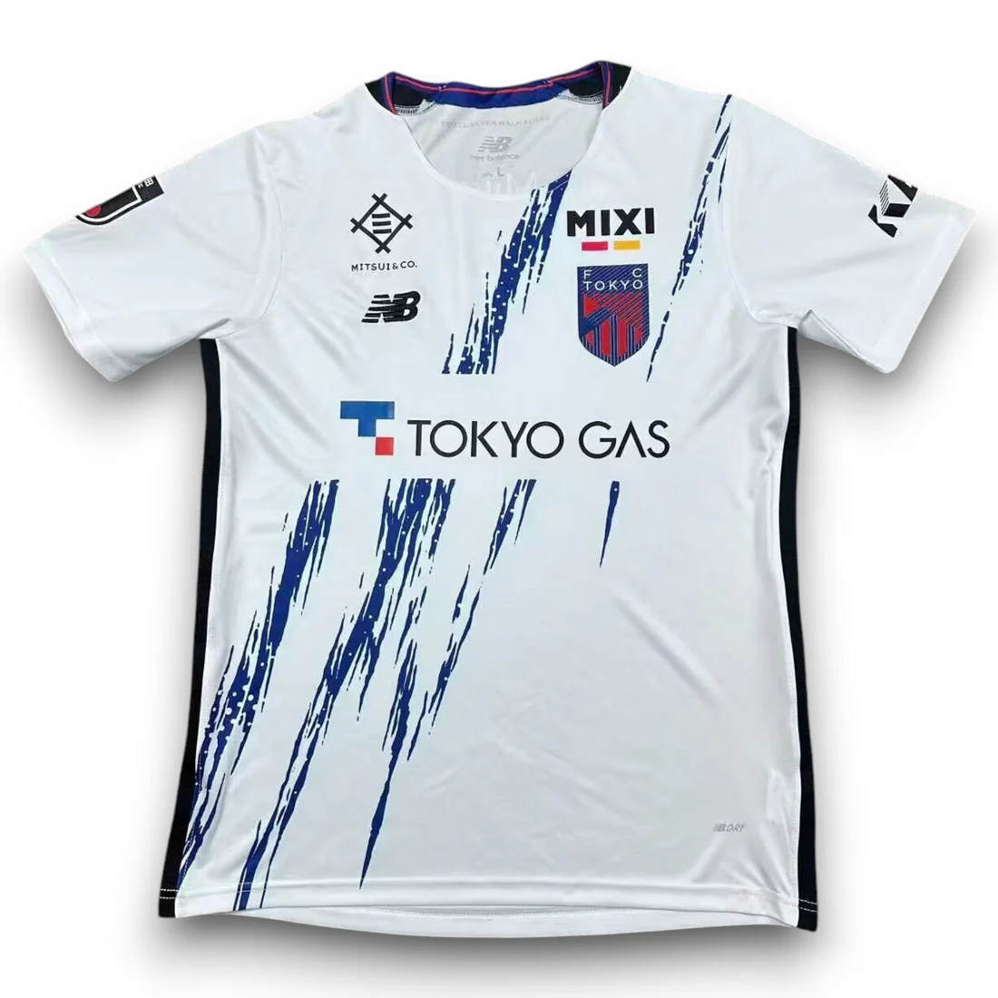 FC Tokyo Away Jersey 2026/27 front view in white with navy brushstroke graphics, club crest and Tokyo Gas sponsor