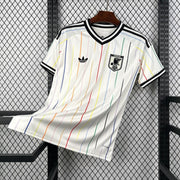 Japan Away Jersey 2026 front view with white base, multicolour vertical stripes, black collar trim, and Japan crest