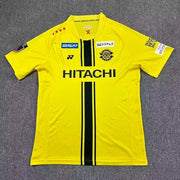 Kashiwa Reysol Home Jersey 2026/27 front view in bright yellow with black centre stripes, club crest and HITACHI sponsor