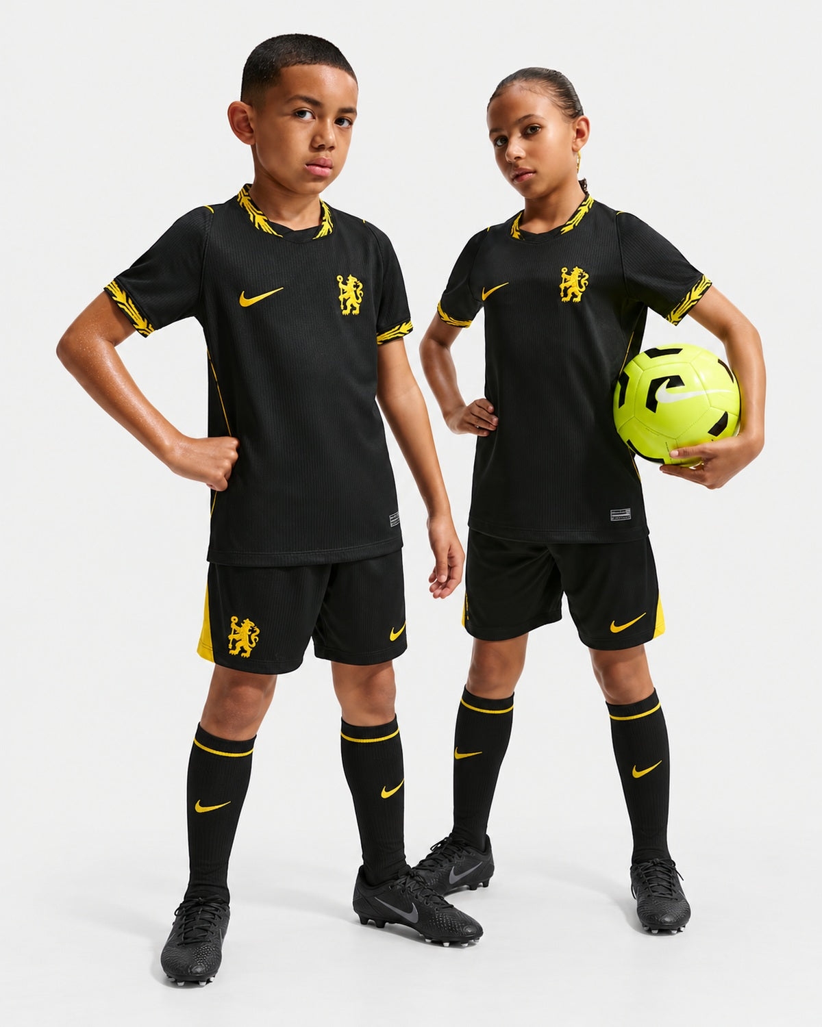 Kids wearing black and gold football jerseys
