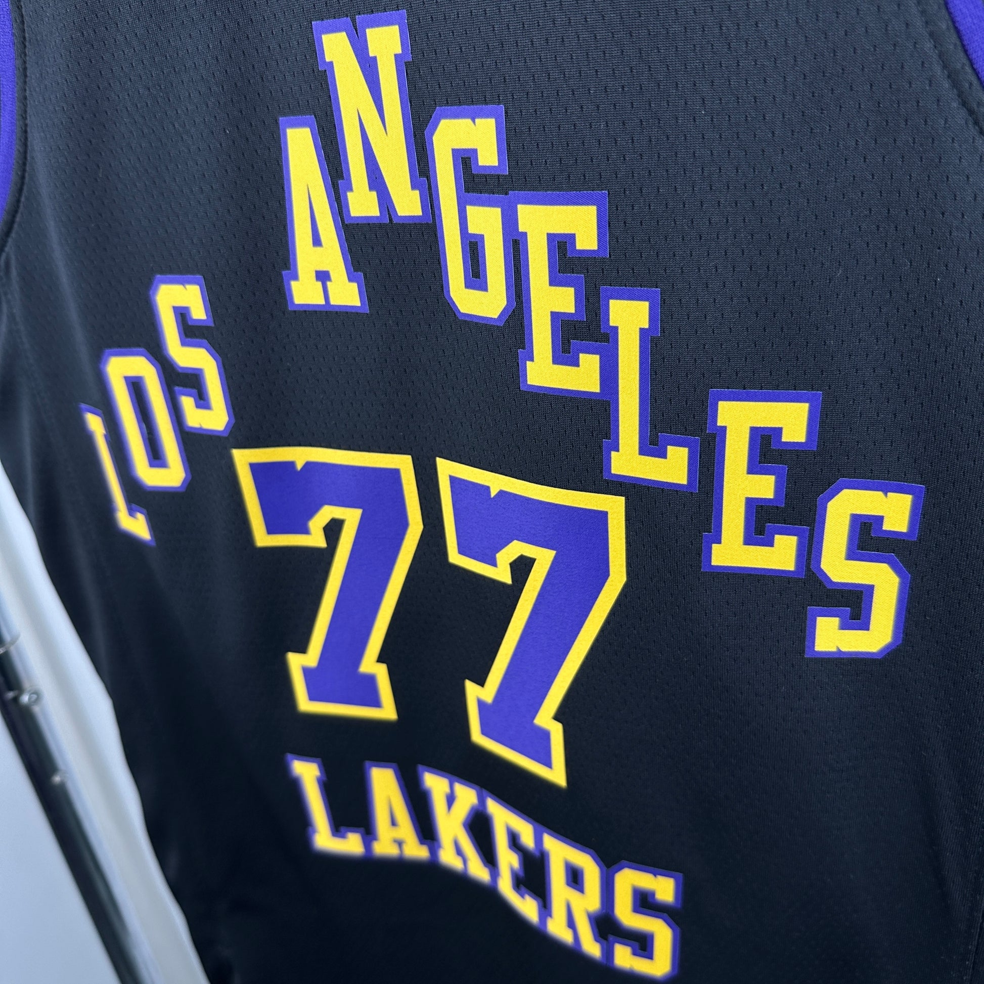 Los Angeles Lakers 2025/26 City Edition swingman jersey Luka Dončić number 77 black purple gold front and back view