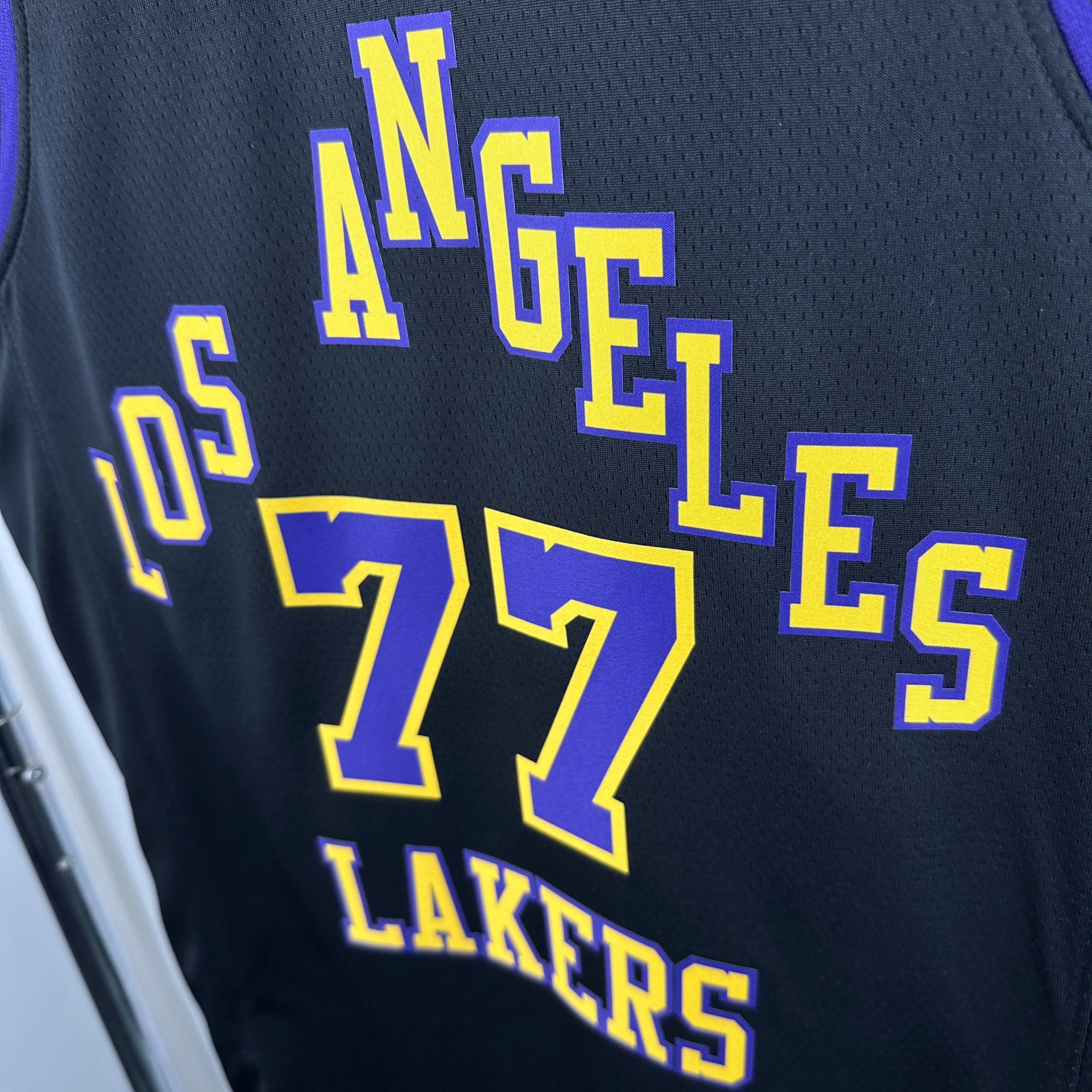 Los Angeles Lakers 2025/26 City Edition swingman jersey Luka Dončić number 77 black purple gold front and back view