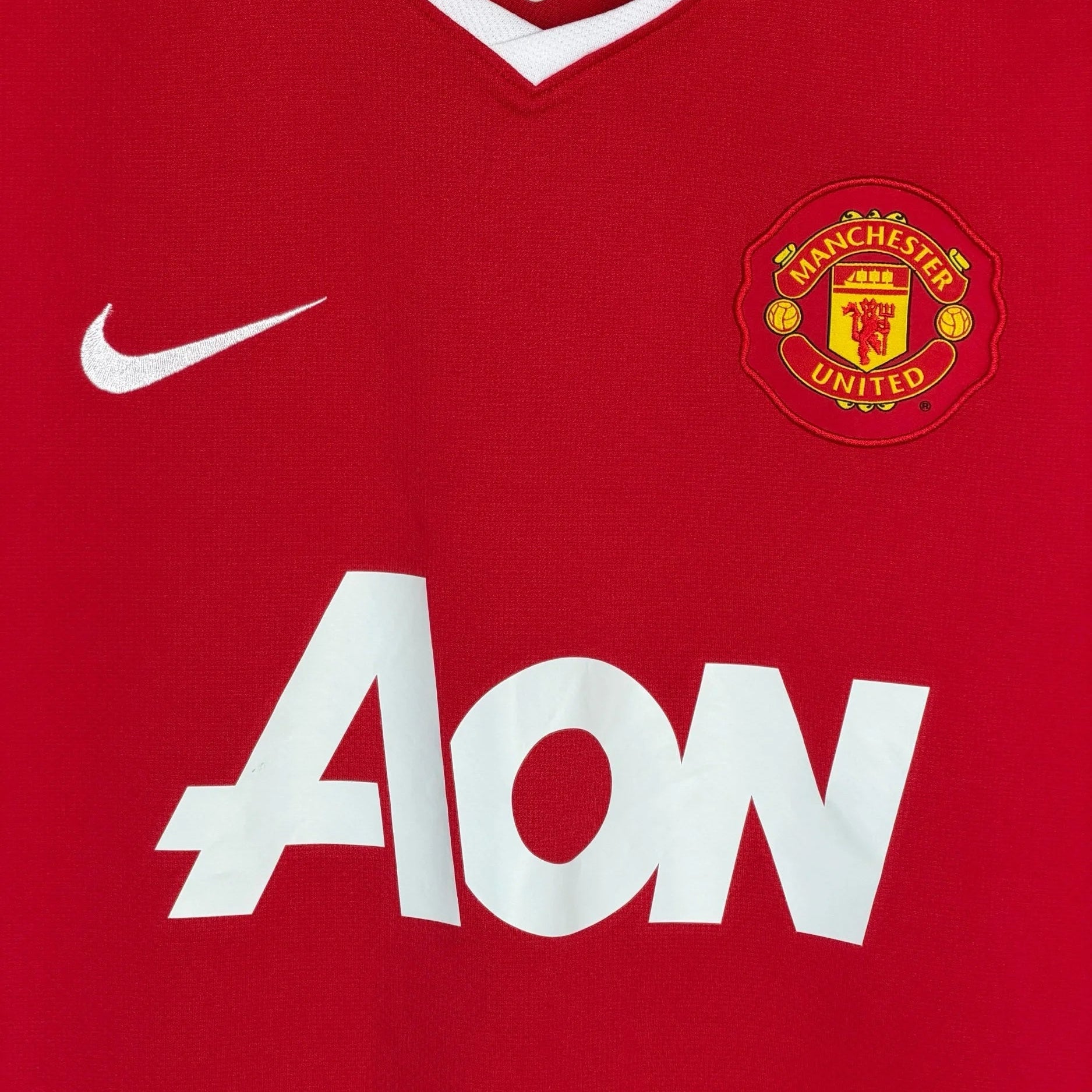Manchester United 2010/11 home kit club crest close up
