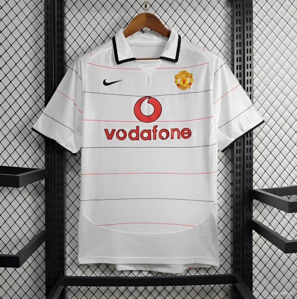 Front view of the Manchester United Third Jersey 2003/04 in white with fine horizontal pinstripes, fold-over collar, club crest, chest logo, and Vodafone sponsor