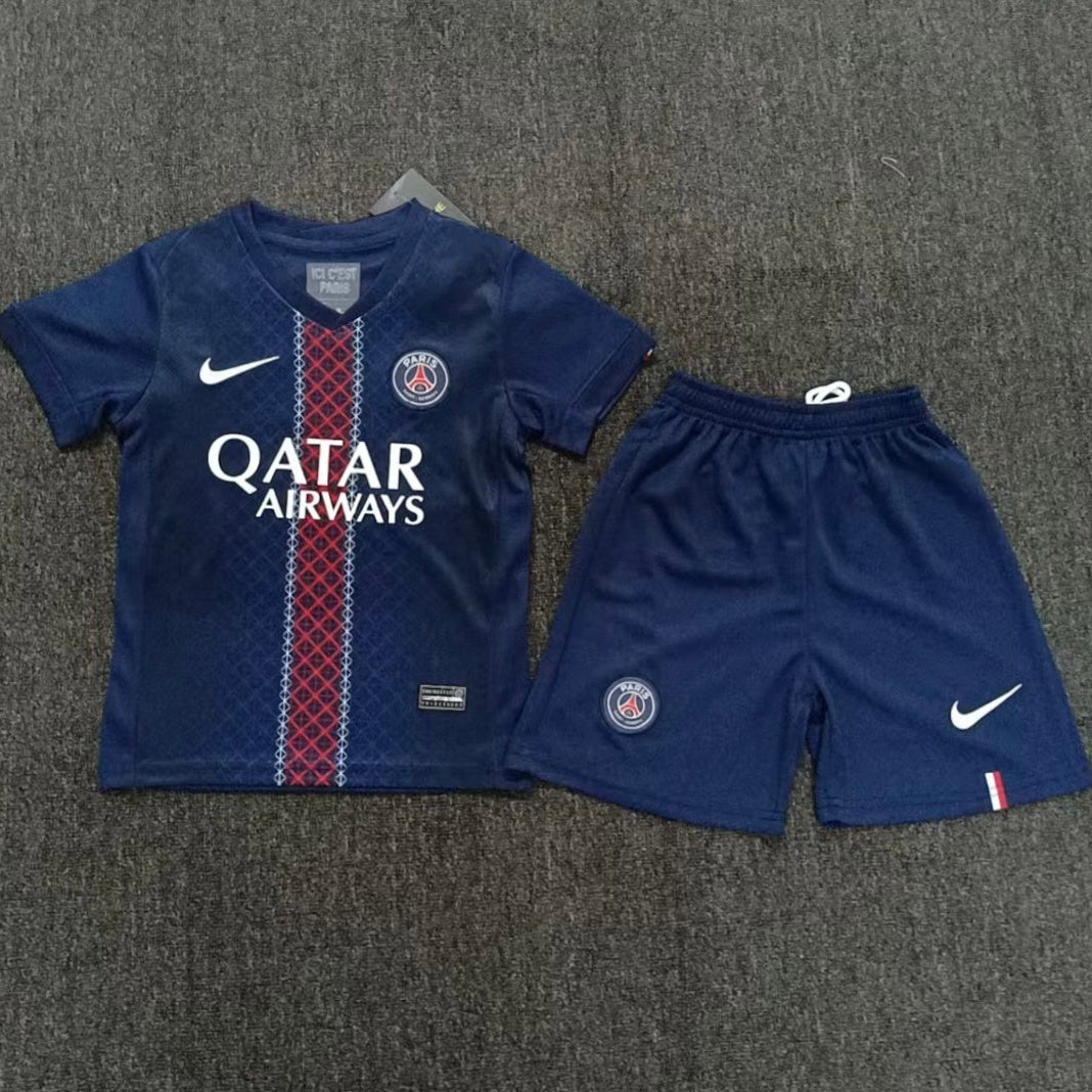 Nike PSG home kit 2025 26 kids front view navy jersey with red white stripe and shorts
