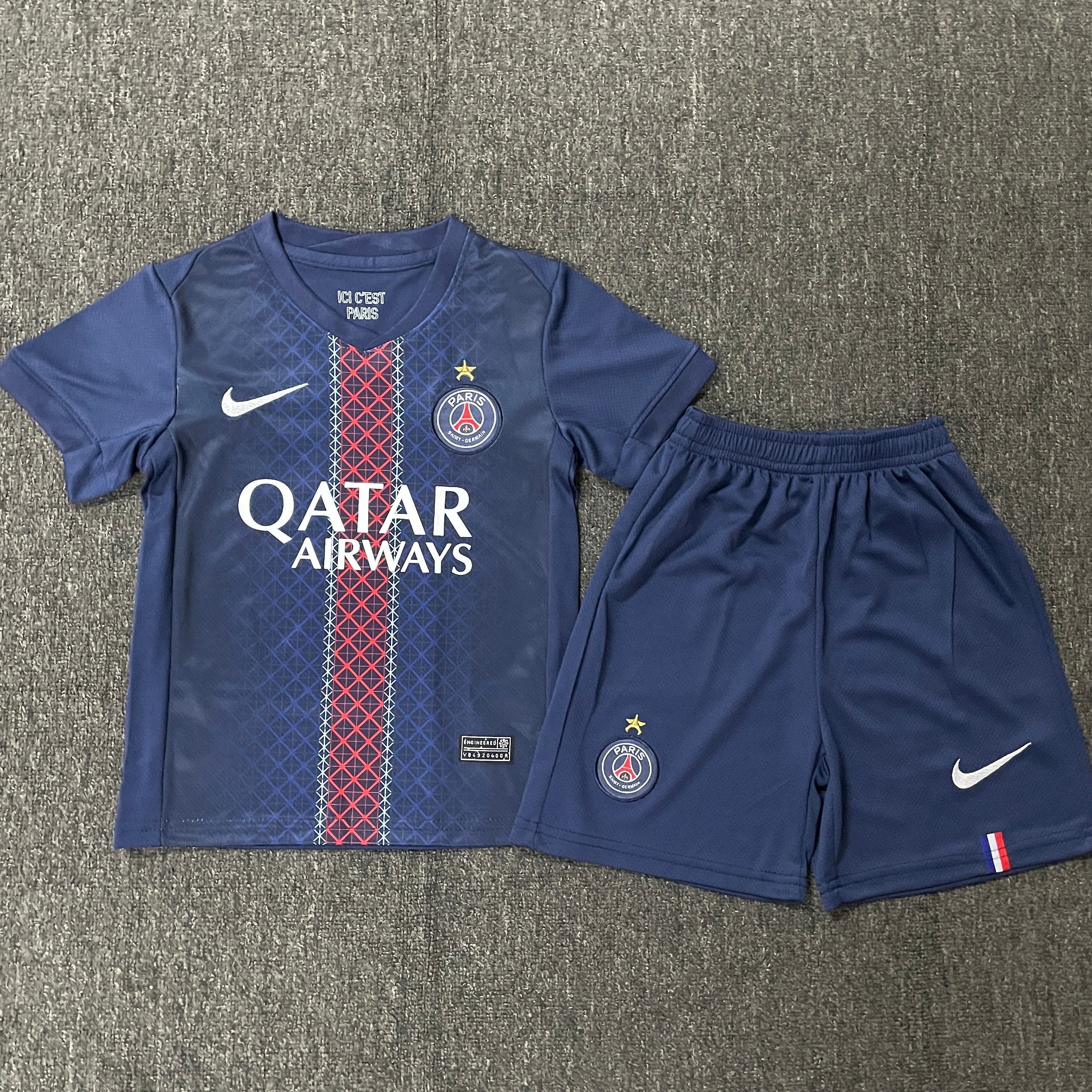 Nike PSG home kit 2025 26 with star kids front view navy jersey with red white stripe and shorts
