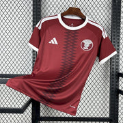Qatar home kit 2026 front view maroon World Cup jersey
