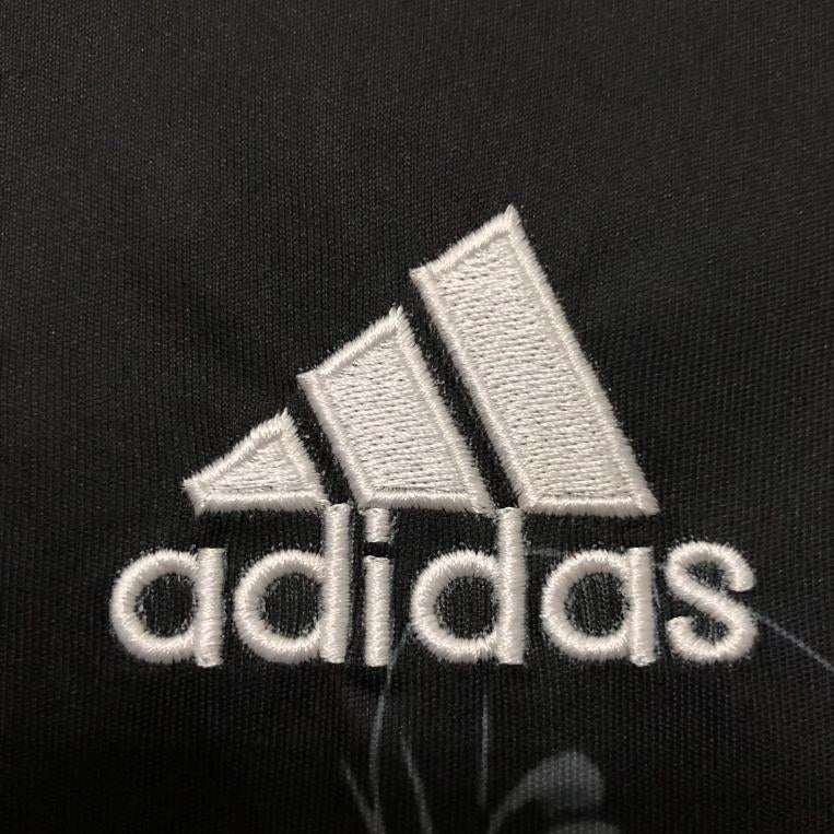 Real Madrid adidas logo detail on black dragon jersey
