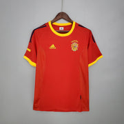 Spain Home Jersey 2002 front view in red with yellow trim, dark shoulder details and Spain crest