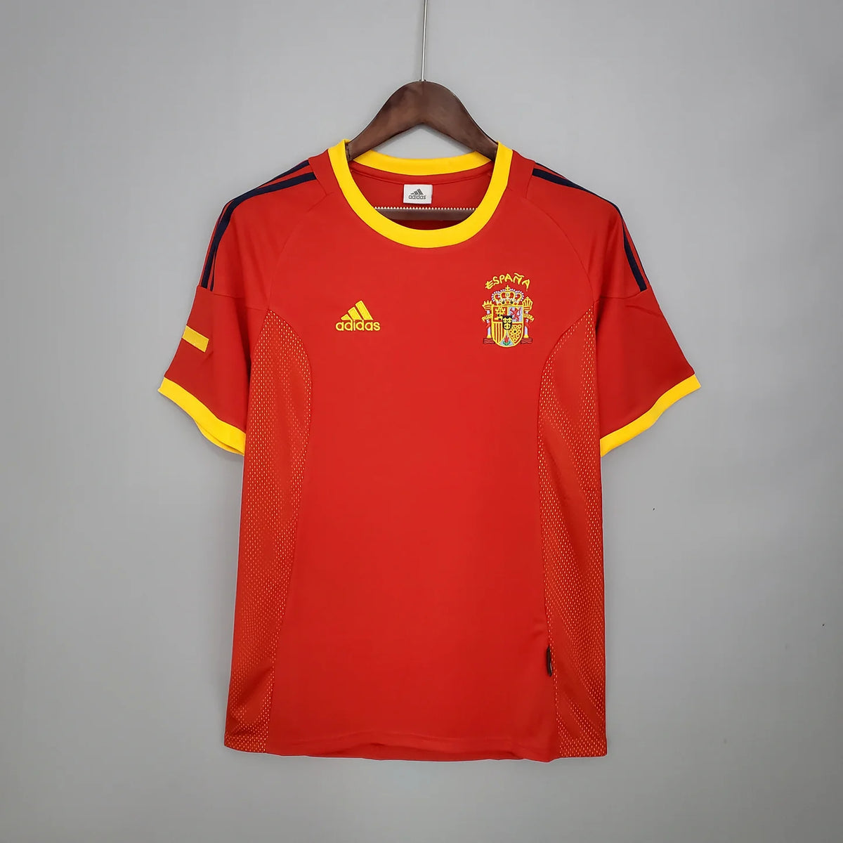 Spain Home Jersey 2002 front view in red with yellow trim, dark shoulder details and Spain crest